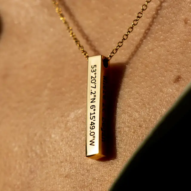 Gold bar necklace engraved with coordinates